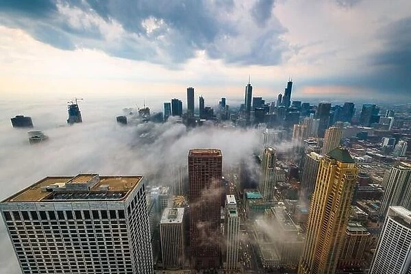 Chicago, IL, USA downtown cityscape with a fog rolling in