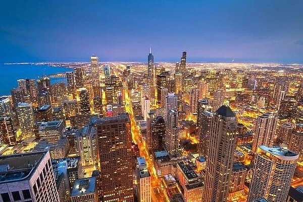 Chicago, Illinois, USA aerial cityscape with financial district buildings and Lake Michigan at dusk