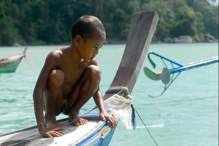 Framed Print : Child, boy, crouching on a boat, Chao Naam, Moken, Surin Islands Marine National Park, Ko Surin Noi, Phang Nga, Thailand Framed Print : Child, boy, crouching on a boat, Chao Naam, Moken, Surin Islands Marine National Park, Ko Surin Noi, Phang Nga, Thailand