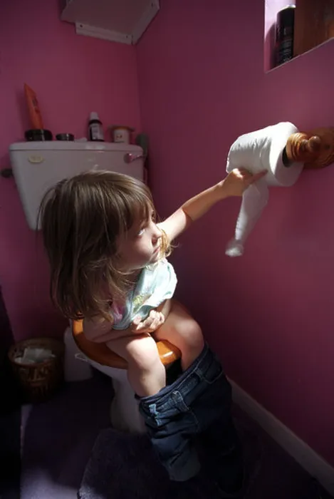Framed Print : A child learning to use the toilet Framed Print : A child learning to use the toilet