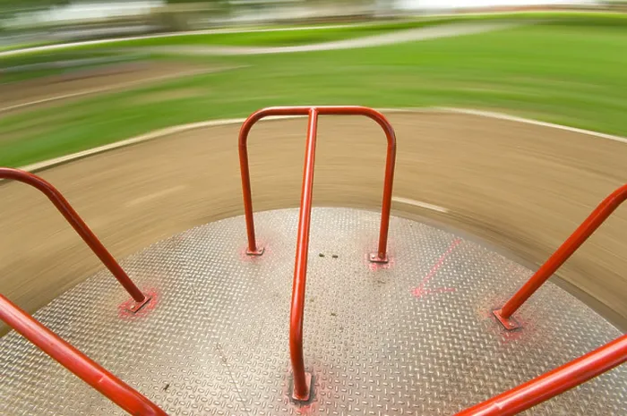 Framed Print : Children's Playground equipment - merry go round spinning very fast Framed Print : Children's Playground equipment - merry go round spinning very fast