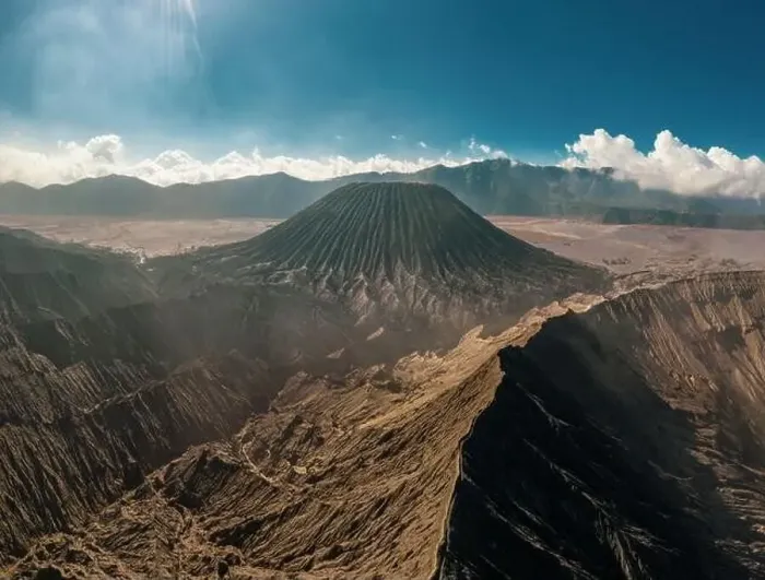 Framed Print : Cinematic shot aerial view of Mount Bromo crater edge with active volcano smoke in East Java Framed Print : Cinematic shot aerial view of Mount Bromo crater edge with active volcano smoke in East Java