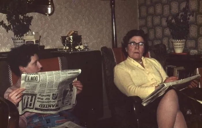 Framed Print : circa 1967 Two women reading newspapers in a typical living room in England Photograph by Tony Henshaw Framed Print : circa 1967 Two women reading newspapers in a typical living room in England Photograph by Tony Henshaw