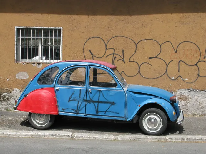 Framed Print : one citroen 2cv covered with graffiti in street in city town Framed Print : one citroen 2cv covered with graffiti in street in city town