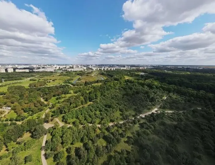 Framed Print : City landscape. Nearby there is a park area. Blue sky with white clouds. Aerial photography of the panorama Framed Print : City landscape. Nearby there is a park area. Blue sky with white clouds. Aerial photography of the panorama
