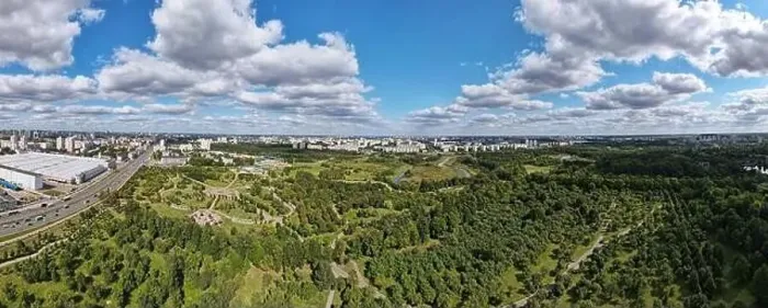 Framed Print : City landscape. Nearby there is a park area. Blue sky with white clouds. Aerial photography of the panorama Framed Print : City landscape. Nearby there is a park area. Blue sky with white clouds. Aerial photography of the panorama