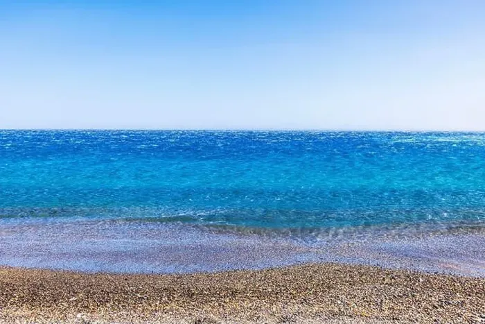 Framed Print : Clear blue Mediterranean sea with small pebbles on shore under sunny sky, with calm water stretching to horizon Framed Print : Clear blue Mediterranean sea with small pebbles on shore under sunny sky, with calm water stretching to horizon