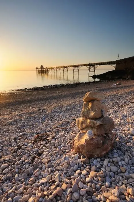 Framed Print : Clevedon Pier, Somerset, with a stone stack in the foreground, during the golden hour before sunset Framed Print : Clevedon Pier, Somerset, with a stone stack in the foreground, during the golden hour before sunset