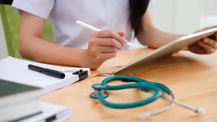 Framed Print : Close up doctor examining medical report while using computer tablet. Medical and healthcare concept Framed Print : Close up doctor examining medical report while using computer tablet. Medical and healthcare concept