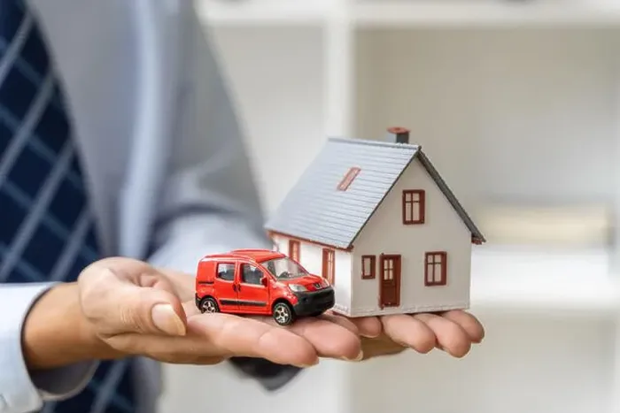 Framed Print : Close up hands of a male realtor holding a house and car model in his hands, home buying or real estate concept Framed Print : Close up hands of a male realtor holding a house and car model in his hands, home buying or real estate concept