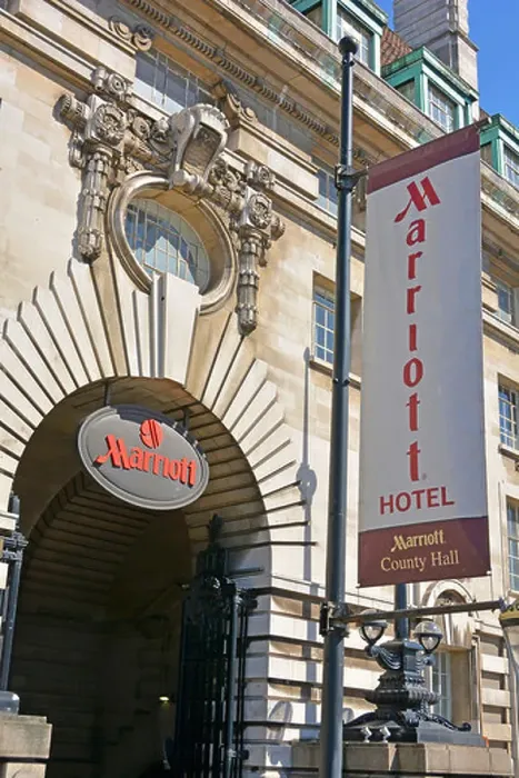 Framed Print : Close up Marriott Hotel sign & banner above entrance converted from part of old LCC & GLC office building at County Framed Print : Close up Marriott Hotel sign & banner above entrance converted from part of old LCC & GLC office building at County