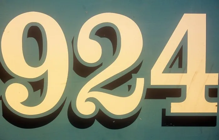 Framed Print : Close up of stylish cream numbers 924 painted to look as though casting shadows on grey-green background Framed Print : Close up of stylish cream numbers 924 painted to look as though casting shadows on grey-green background