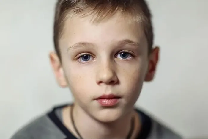 Framed Print : close-up portrait of serious caucasian boy with freckles in casual wear, boy looking in camera Framed Print : close-up portrait of serious caucasian boy with freckles in casual wear, boy looking in camera