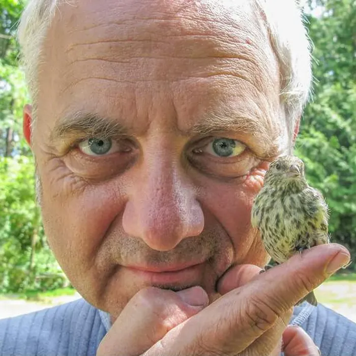 Framed Print : Close-up portrait of a man holding a Sparrow on his finger, British Columbia, Canada