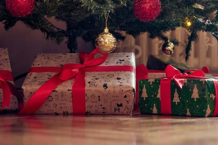 Framed Print : Close-up of presents spread over the floor under the christmas tree on a beautiful holiday at home Framed Print : Close-up of presents spread over the floor under the christmas tree on a beautiful holiday at home