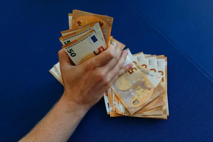 Framed Print : close-up view of man hand holding a pile of money Framed Print : close-up view of man hand holding a pile of money
