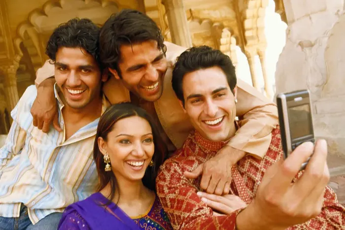 Framed Print : Close-up of three young men and a young woman looking at a mobile phone and smiling, Agra, Uttar Pradesh, India Framed Print : Close-up of three young men and a young woman looking at a mobile phone and smiling, Agra, Uttar Pradesh, India