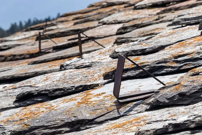 Framed Print : Close up view of old metal snow guards on a slate roof in the Italian Alps Framed Print : Close up view of old metal snow guards on a slate roof in the Italian Alps