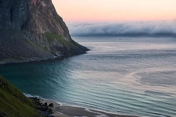 The clouds are rolling from the sea at summer evening in Lofoten, Norway