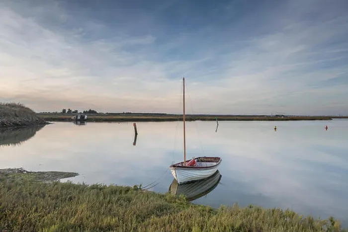 Framed Print : Clouds and a small boat reflected in the still water at Walton & Frinton Yacht Club, Walton on the Naze, Essex, UK Framed Print : Clouds and a small boat reflected in the still water at Walton & Frinton Yacht Club, Walton on the Naze, Essex, UK