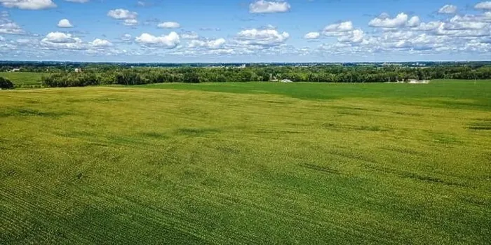 Framed Print : A cloudy blue sky extends to the horizon with a massive farm field below surrounded by a rural area in Wisconsin Framed Print : A cloudy blue sky extends to the horizon with a massive farm field below surrounded by a rural area in Wisconsin