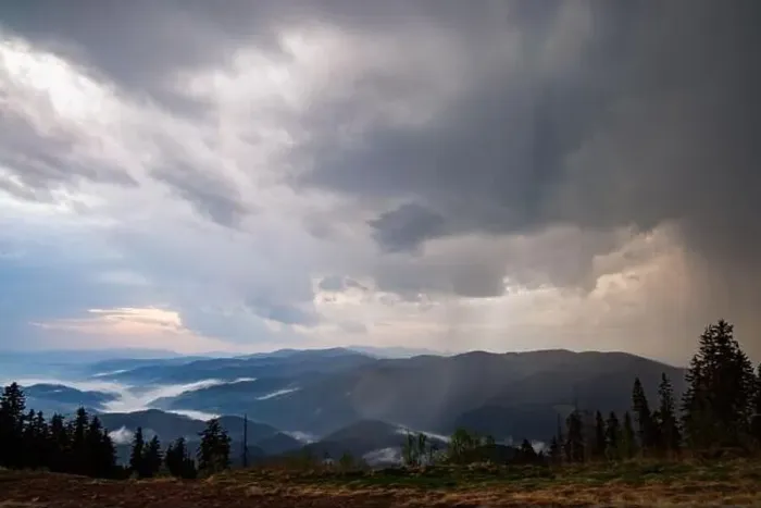 Framed Print : Cold cloudy rainy weather over low hills covered with spruce evergreen forests in Rhodope Mountains against backdrop of