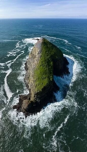 The cold Pacific Ocean washes onto a scenic and rugged seastack off the northern coast of Oregon, not far from Tillamook