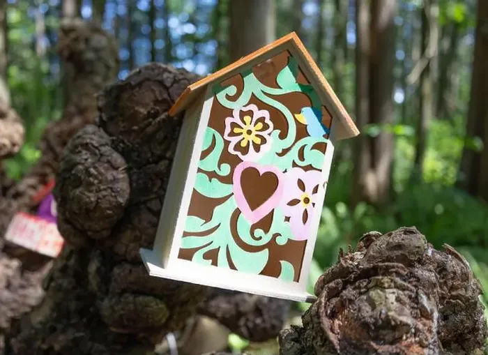 Framed Print : Collection of birdhouses made by children and placed on fallen trees in the forest Framed Print : Collection of birdhouses made by children and placed on fallen trees in the forest