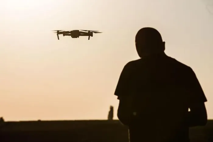 Framed Print : Color image of a man flying a drone at sunrise Framed Print : Color image of a man flying a drone at sunrise