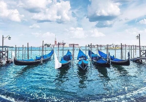 Colorful landscape with clear blue sky on piazza San Marco in Venice. Row of gondolas parked on city pier