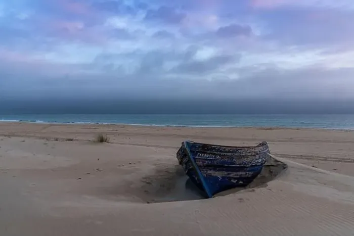 Framed Print : colorful wreck of an old wooden rowboat buried in the sand with a beautiful sunset sky and ocean behind Framed Print : colorful wreck of an old wooden rowboat buried in the sand with a beautiful sunset sky and ocean behind