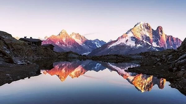 Colourful sunset on Lac Blanc lake in France Alps. Monte Bianco mountain range on background