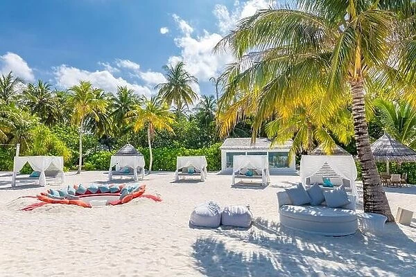 Comfortable chaise with canopy on vip beach seascape. Relaxation zone, tropical resort hotel beach landscape. Palm trees over white sand, vacation