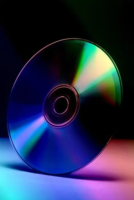 Framed Print : Computer Comm cd compact disc colors blue green purple pink reflection silicon plastic data storage concept technology