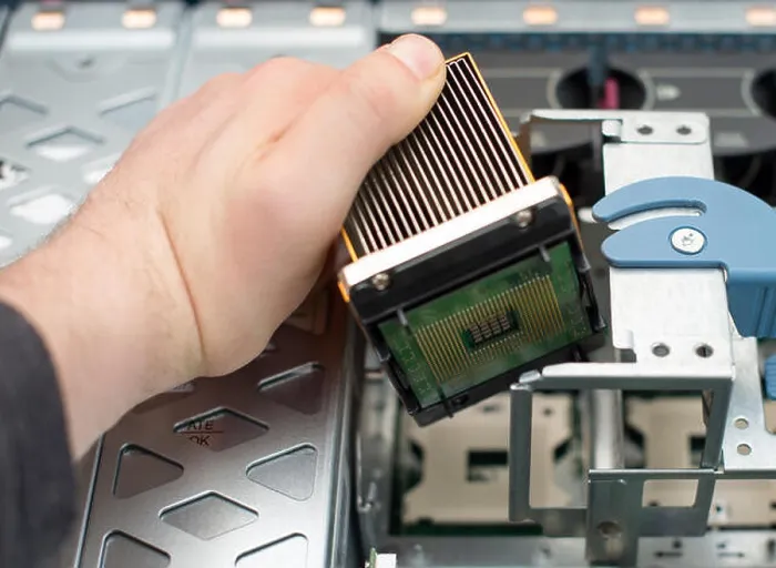 Framed Print : Computer technician installing CPU into motherboard