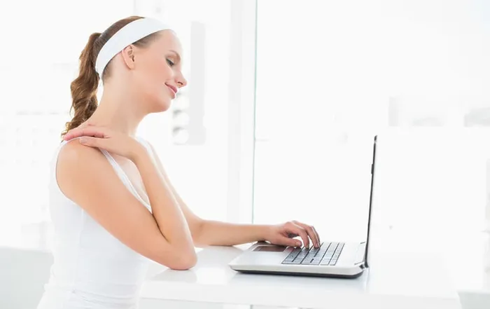Framed Print : Concentrated pretty sportswoman typing on a laptop Framed Print : Concentrated pretty sportswoman typing on a laptop