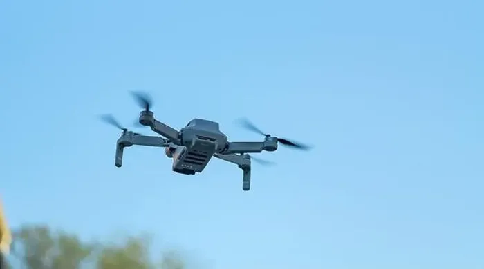 Framed Print : Consumer drone with camera hovering against sky with copy space Framed Print : Consumer drone with camera hovering against sky with copy space