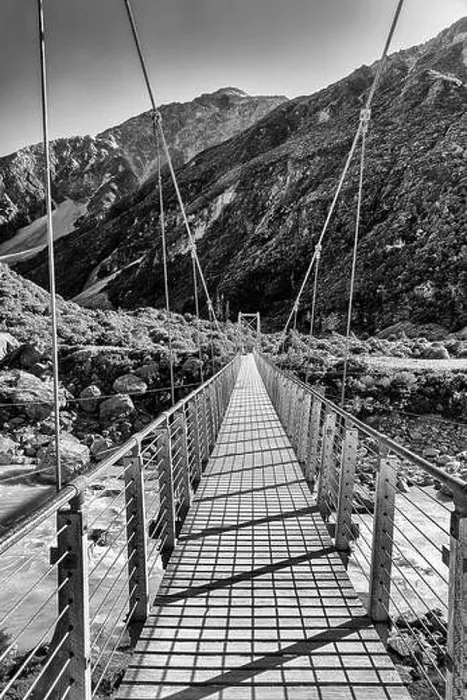 Framed Print : Contrast BW hanging foot walking suspension bridge across Hooker river in scenic mountain valley of New Zealand on a Framed Print : Contrast BW hanging foot walking suspension bridge across Hooker river in scenic mountain valley of New Zealand on a