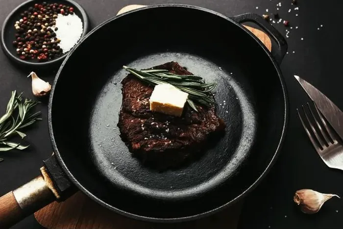 Framed Print : Cooked ribeye steak on cast-iron pan and board with pepper Framed Print : Cooked ribeye steak on cast-iron pan and board with pepper
