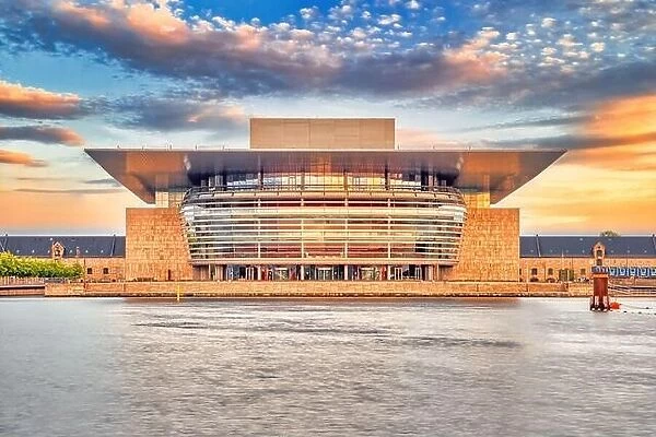 Copenhagen, Denmark - July 02, 2021: The Copenhagen Opera House in the evening with sunset warm light and colorful clouds