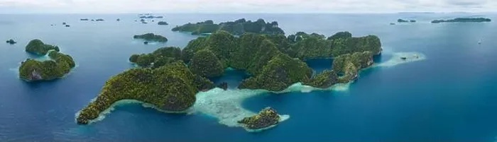 Framed Print : Coral reefs surround the rugged limestone islands that rise from Raja Ampat's seascape. This remote part of Indonesia has high marine biodiversity Framed Print : Coral reefs surround the rugged limestone islands that rise from Raja Ampat's seascape. This remote part of Indonesia has high marine biodiversity