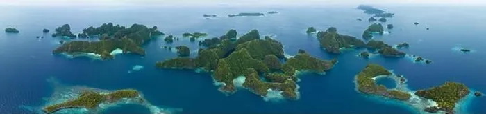 Framed Print : Coral reefs surround the rugged limestone islands that rise from Raja Ampat's seascape. This remote part of Indonesia has high marine biodiversity Framed Print : Coral reefs surround the rugged limestone islands that rise from Raja Ampat's seascape. This remote part of Indonesia has high marine biodiversity