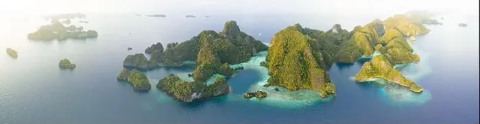 Framed Print : Coral reefs surround the rugged limestone islands that rise from Raja Ampat's seascape. This remote part of Indonesia has high marine biodiversity Framed Print : Coral reefs surround the rugged limestone islands that rise from Raja Ampat's seascape. This remote part of Indonesia has high marine biodiversity