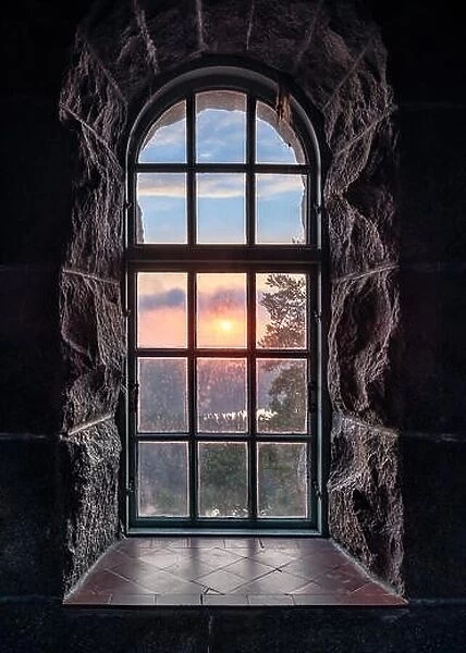 Cosy view looking through an old window with sunset at autumn morning in National Park, Finland