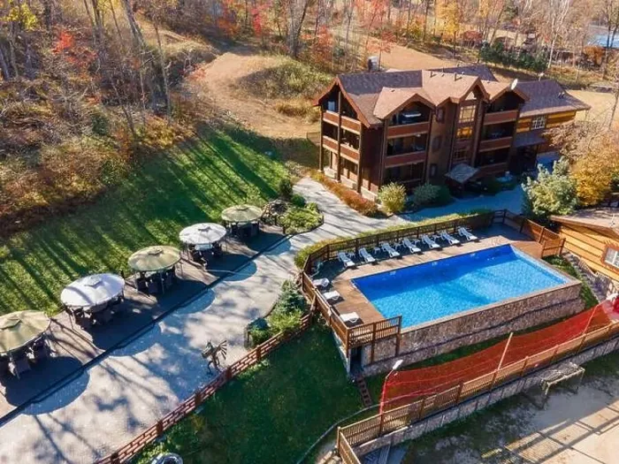Framed Print : Country recreation center located in the woods with a large blue pool, sun loungers and tables. Photo from the drone