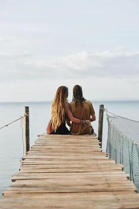 Framed Print : Couple in love sitting on wooden pier and enjoying beautiful seascape, view from the back Framed Print : Couple in love sitting on wooden pier and enjoying beautiful seascape, view from the back