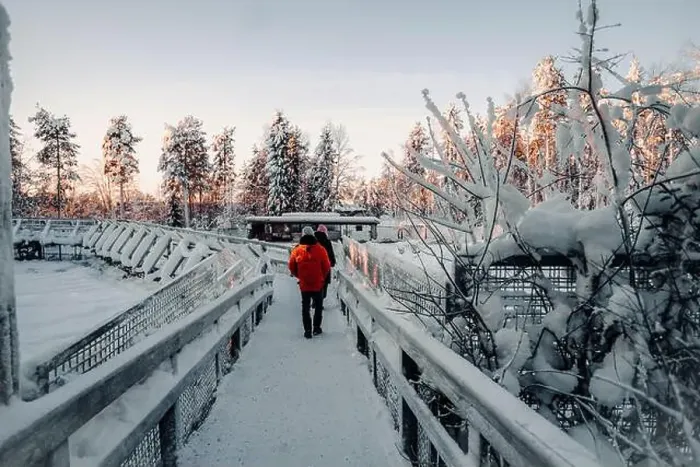 Framed Print : Couple walking over footbridge in wildlife park in Ranua, Lapland Framed Print : Couple walking over footbridge in wildlife park in Ranua, Lapland