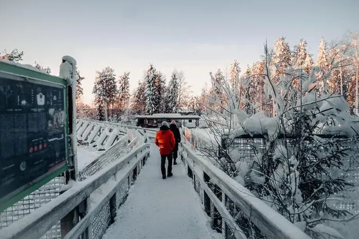 Framed Print : Couple walking over snowy bridge in wildlife in Ranua, Lapland Framed Print : Couple walking over snowy bridge in wildlife in Ranua, Lapland