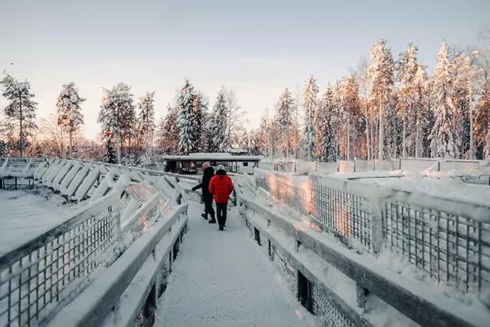 Framed Print : Couple walking over snowy footbridge in wildlife park in Ranua, Lapland Framed Print : Couple walking over snowy footbridge in wildlife park in Ranua, Lapland