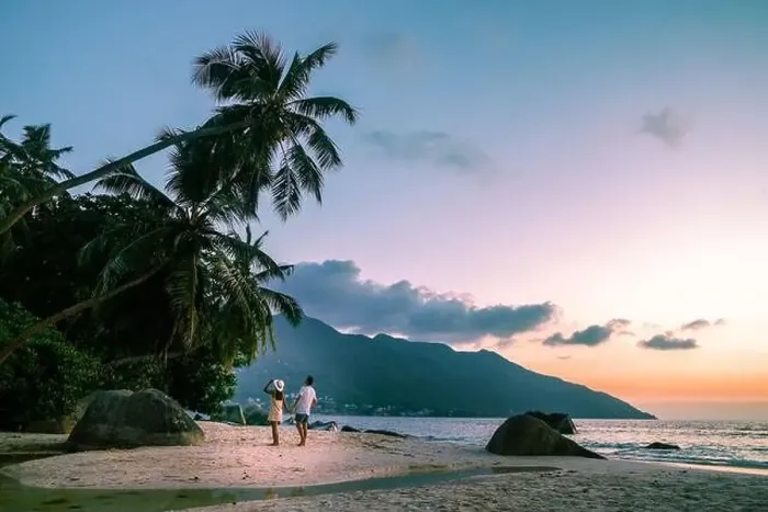 Framed Print : couple walking on tropical beach Mahe Seychelles during sunset Framed Print : couple walking on tropical beach Mahe Seychelles during sunset